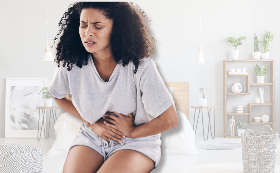 A woman is dealing with heavy periods and anemia and is leaning over because she is cramping